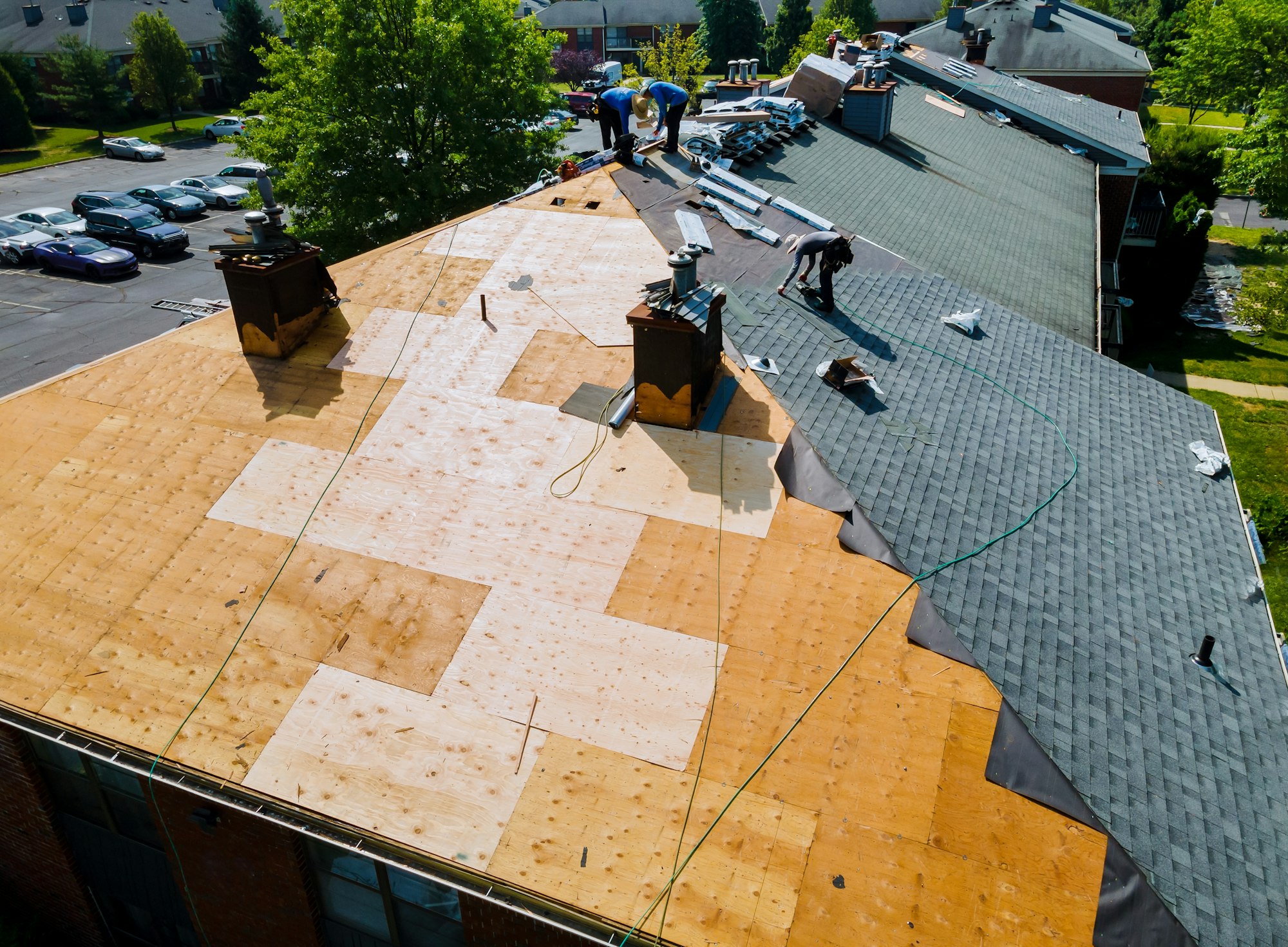 Roof repairs old roof replacement with new shingles of an apartment building